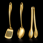 Okura 3-piece utensil set in gold, rounded handles, black studio