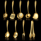 Okura 9-piece utensil set in gold, rounded handles, black studio