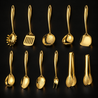 Okura 11-piece utensil set in gold, rounded handles, black studio