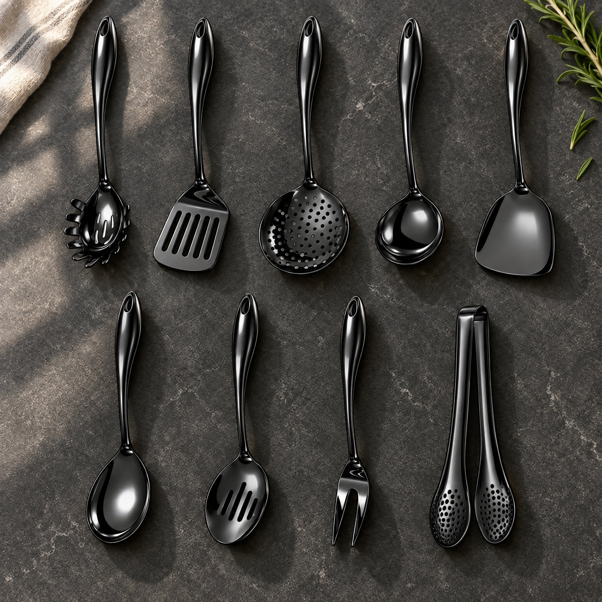 Okura 9-piece utensil set in black arranged on a charcoal kitchen countertop