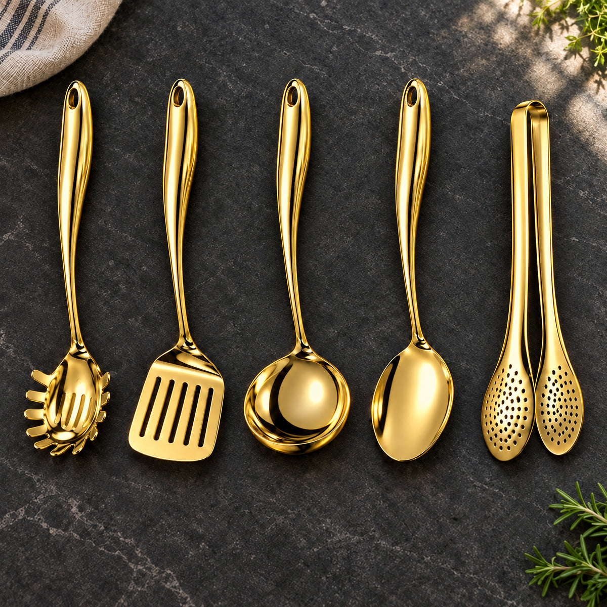 Okura 5-piece utensil set in gold arranged on a charcoal kitchen countertop