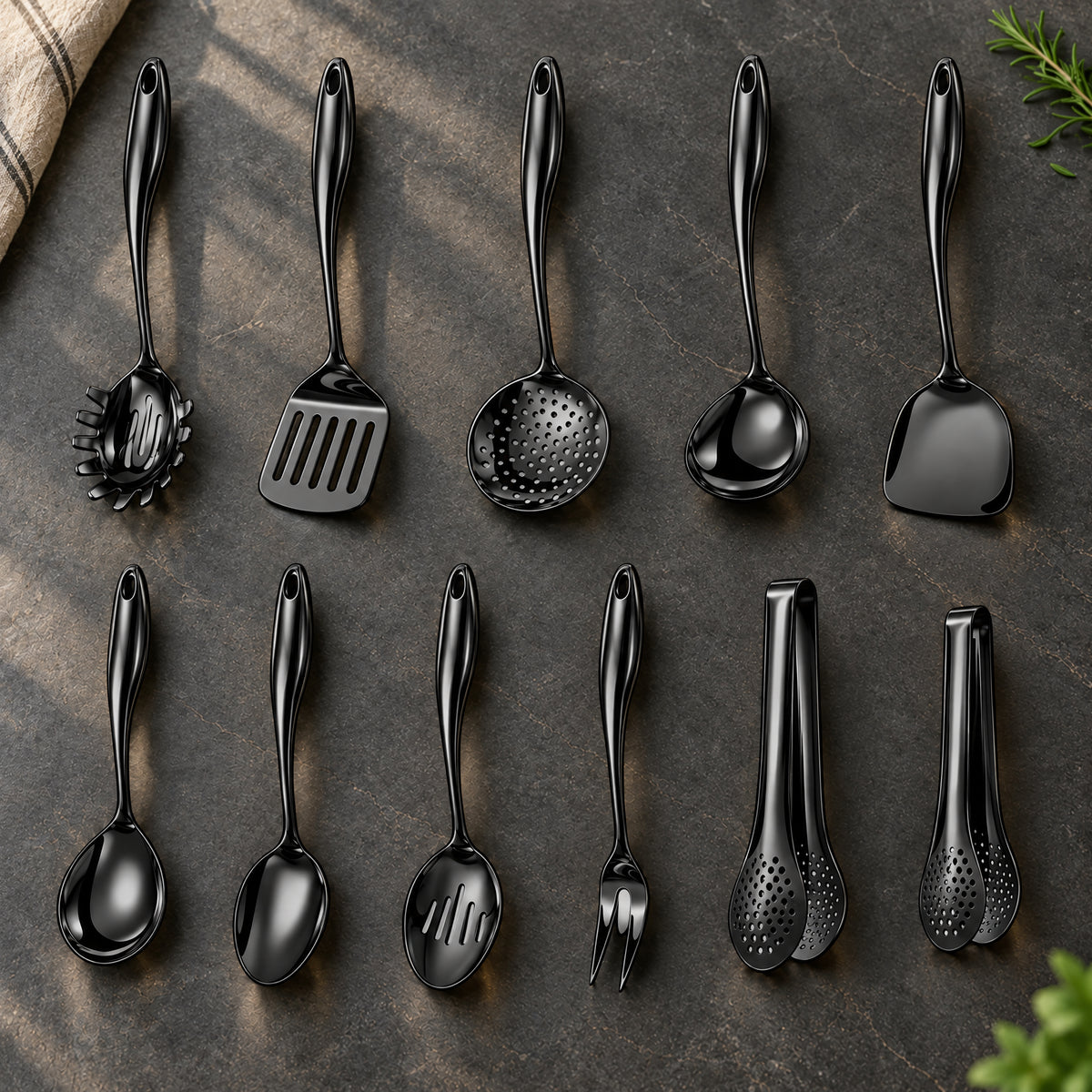 Okura 11-piece utensil set in black arranged on a charcoal kitchen countertop