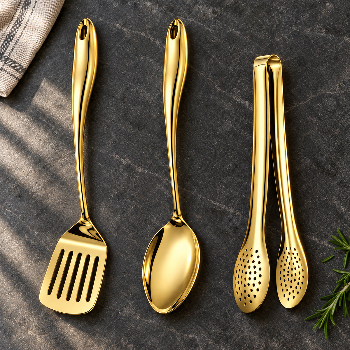 Okura 3-piece utensil set in gold arranged on a charcoal kitchen countertop