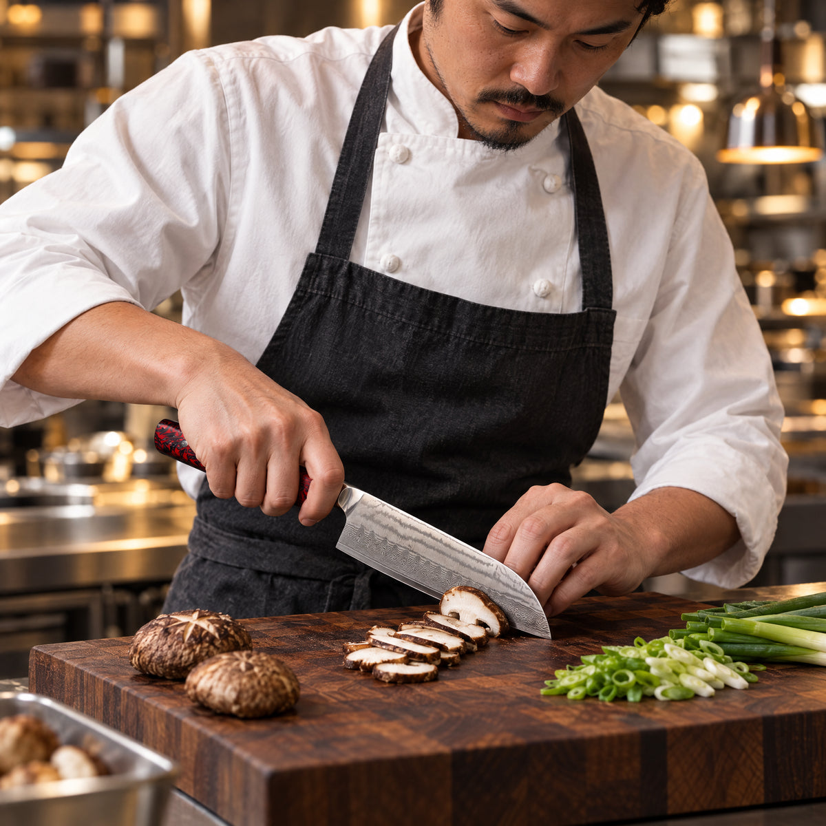 A Japanese chef using the Kurenai Santoku Knife on a wooden cutting board in a professional kitchen