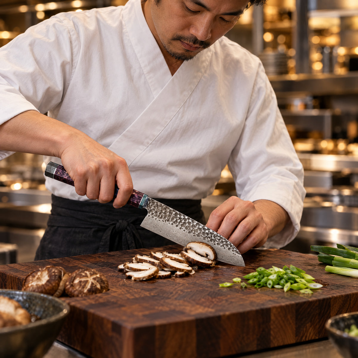 A Japanese chef using the Retsu Santoku Knife on a wooden cutting board in a professional kitchen