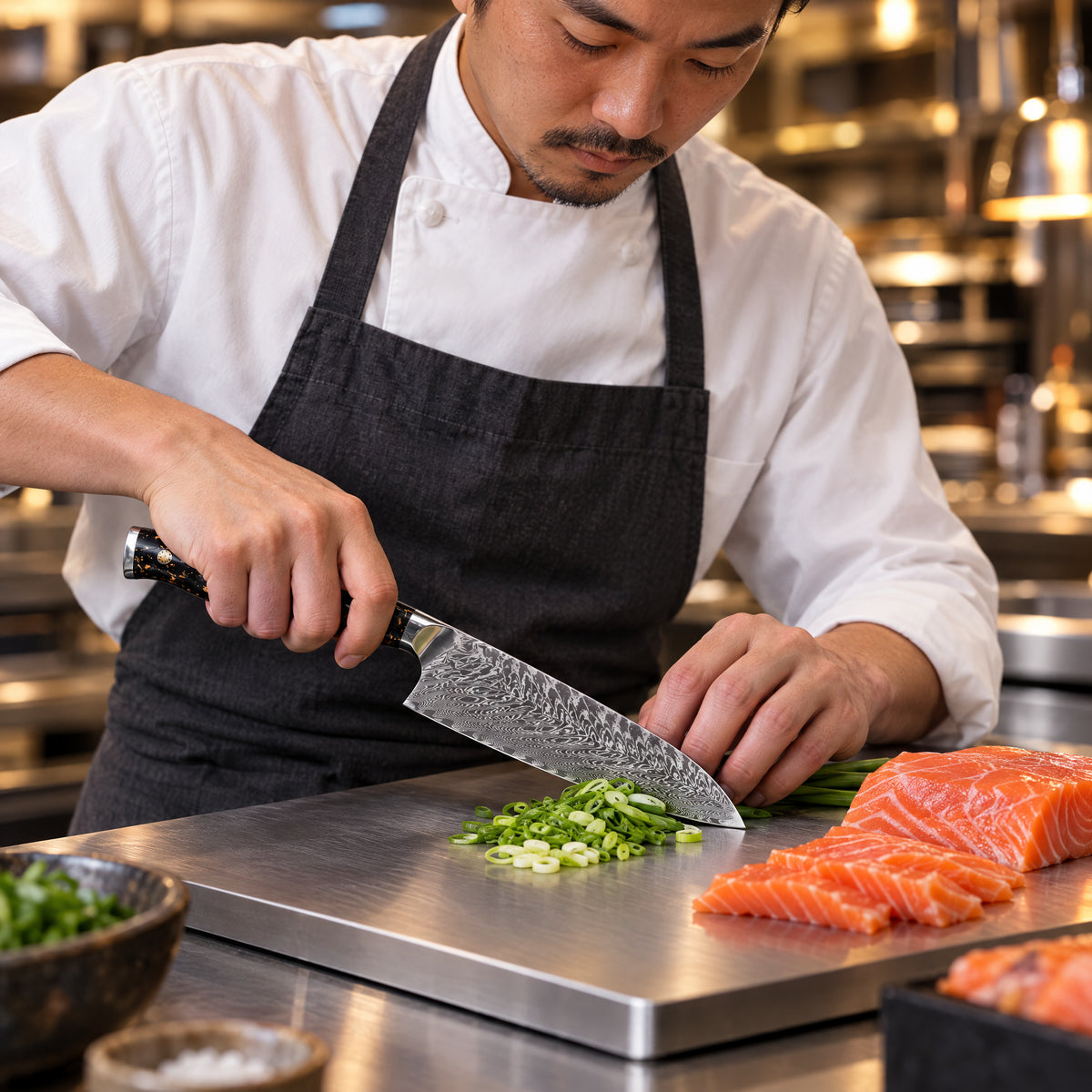 A Japanese chef using the Kogane Santoku Knife on a titanium cutting board in a professional kitchen