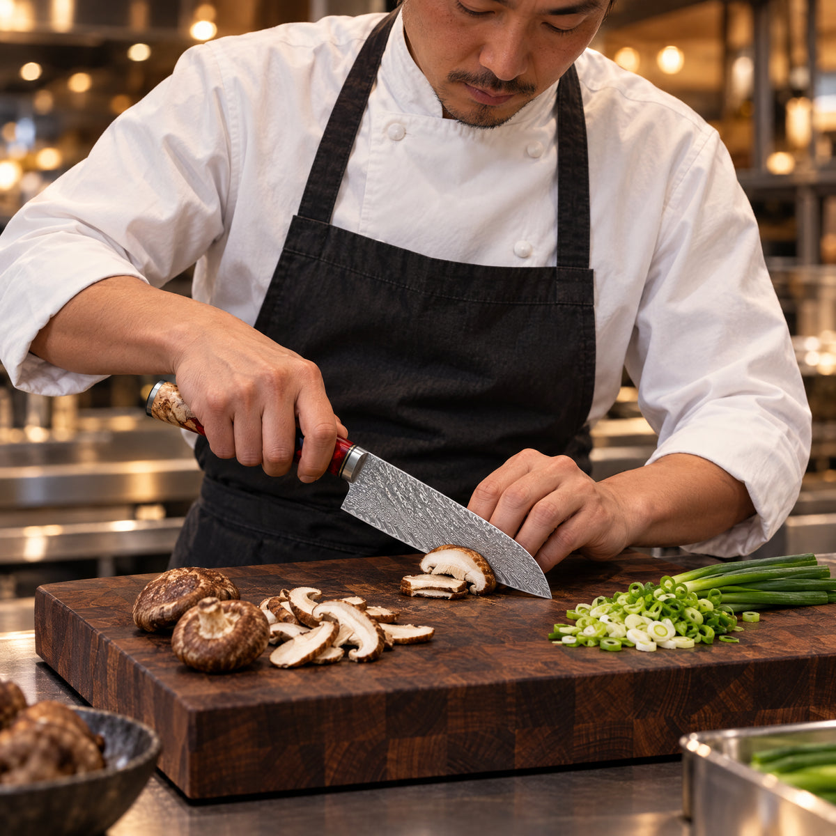 A Japanese chef using the Akagi Santoku Knife on a wooden cutting board in a professional kitchen