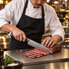 A Japanese chef using the Asahi Gyuto Chef Knife on a titanium cutting board in a professional kitchen