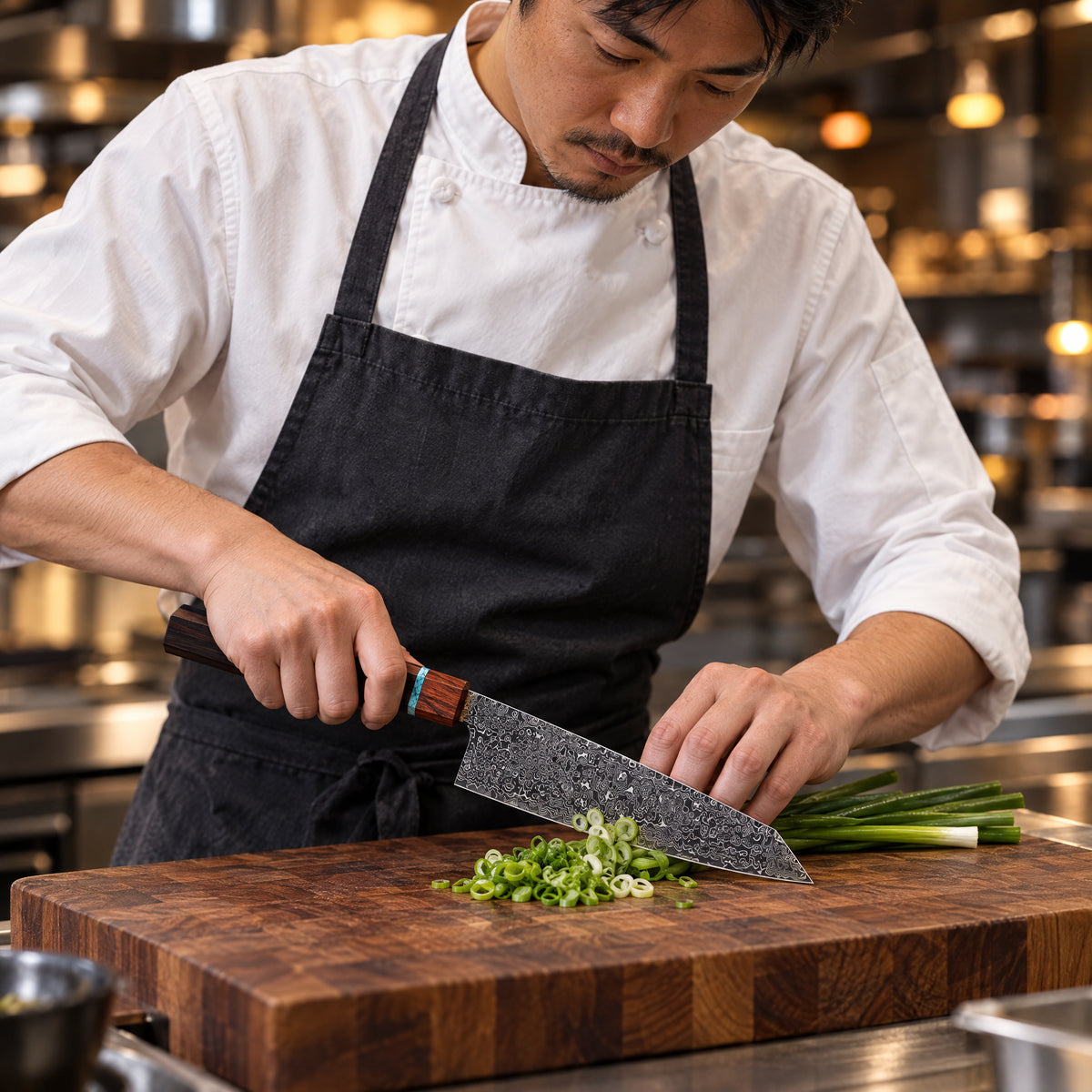 A Japanese chef using the Isamu Kiritsuke Knife on a wooden cutting board in a professional kitchen