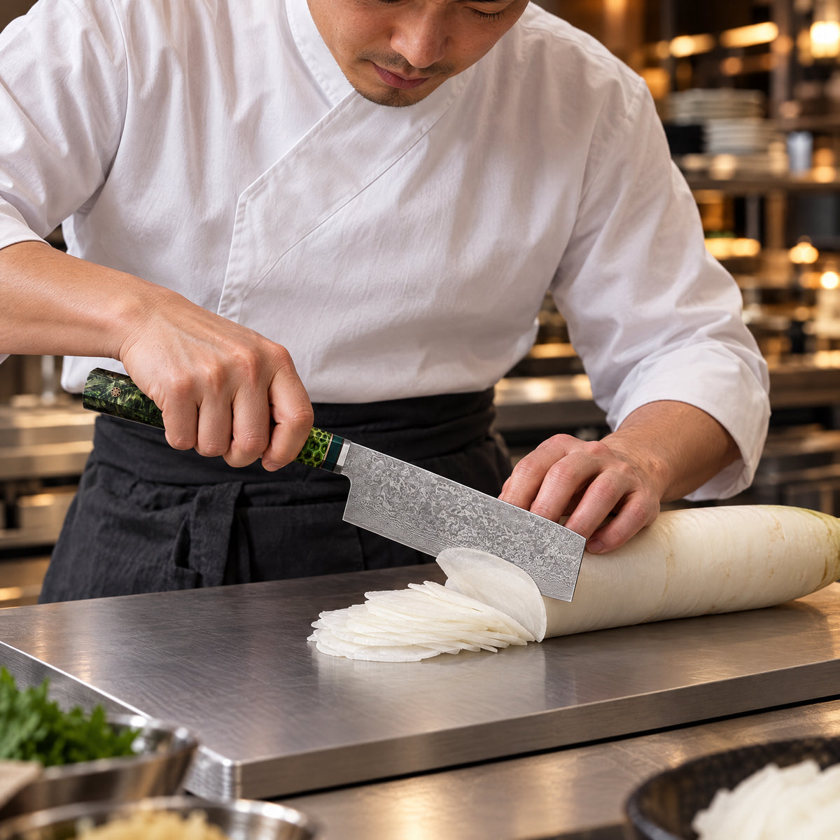 A Japanese chef using the Ibuki Nakiri Knife on a titanium cutting board in a professional kitchen