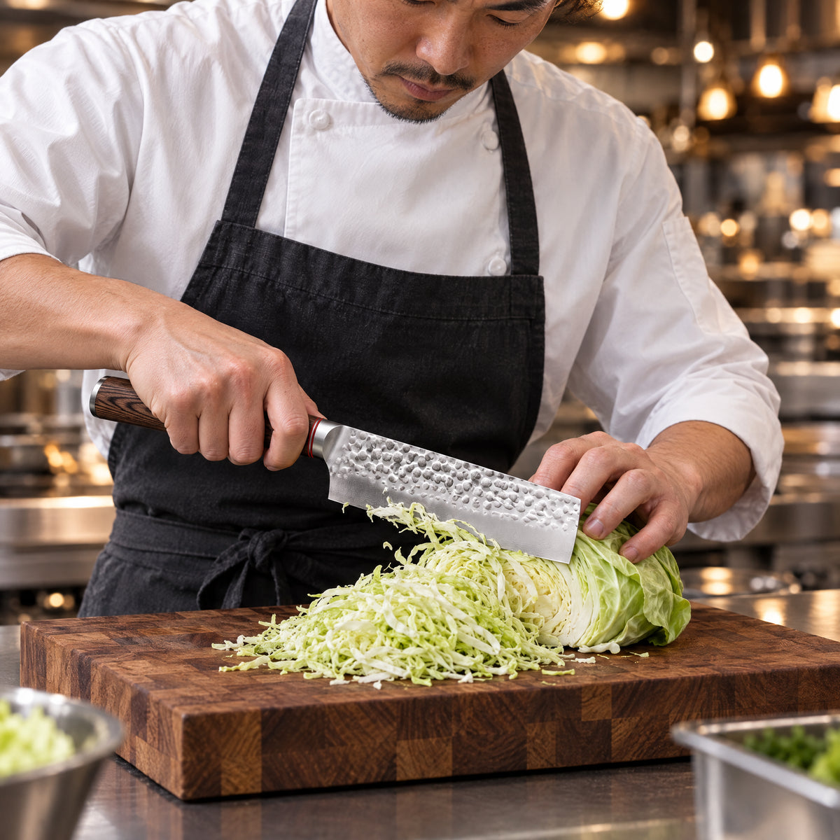 A Japanese chef using the Taiga Nakiri Knife on a wooden cutting board in a professional kitchen