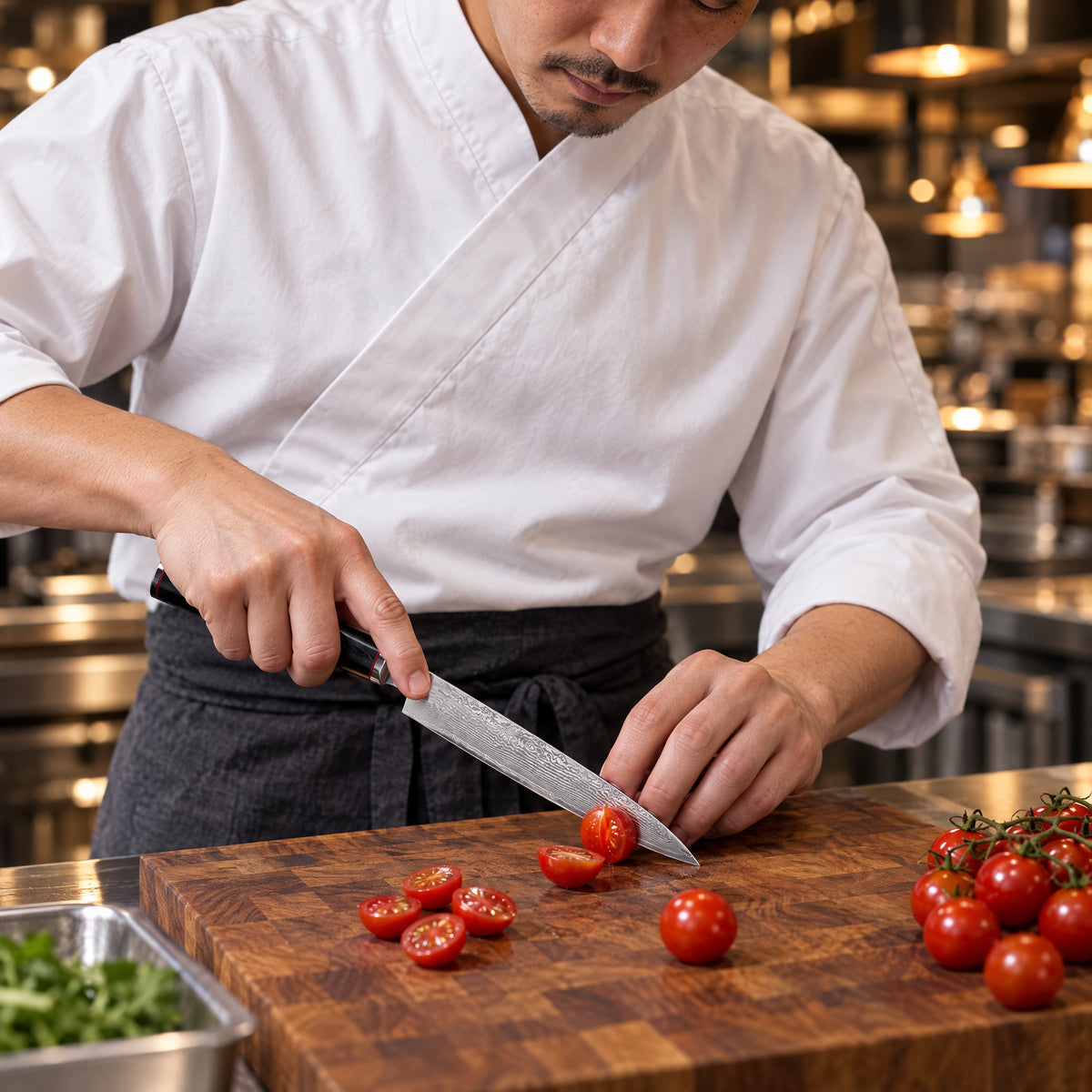 A Japanese chef using the Kurogane Petty Knife on a wooden cutting board in a professional kitchen