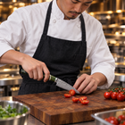 A Japanese chef using the Ibuki Paring Knife on a wooden cutting board in a professional kitchen