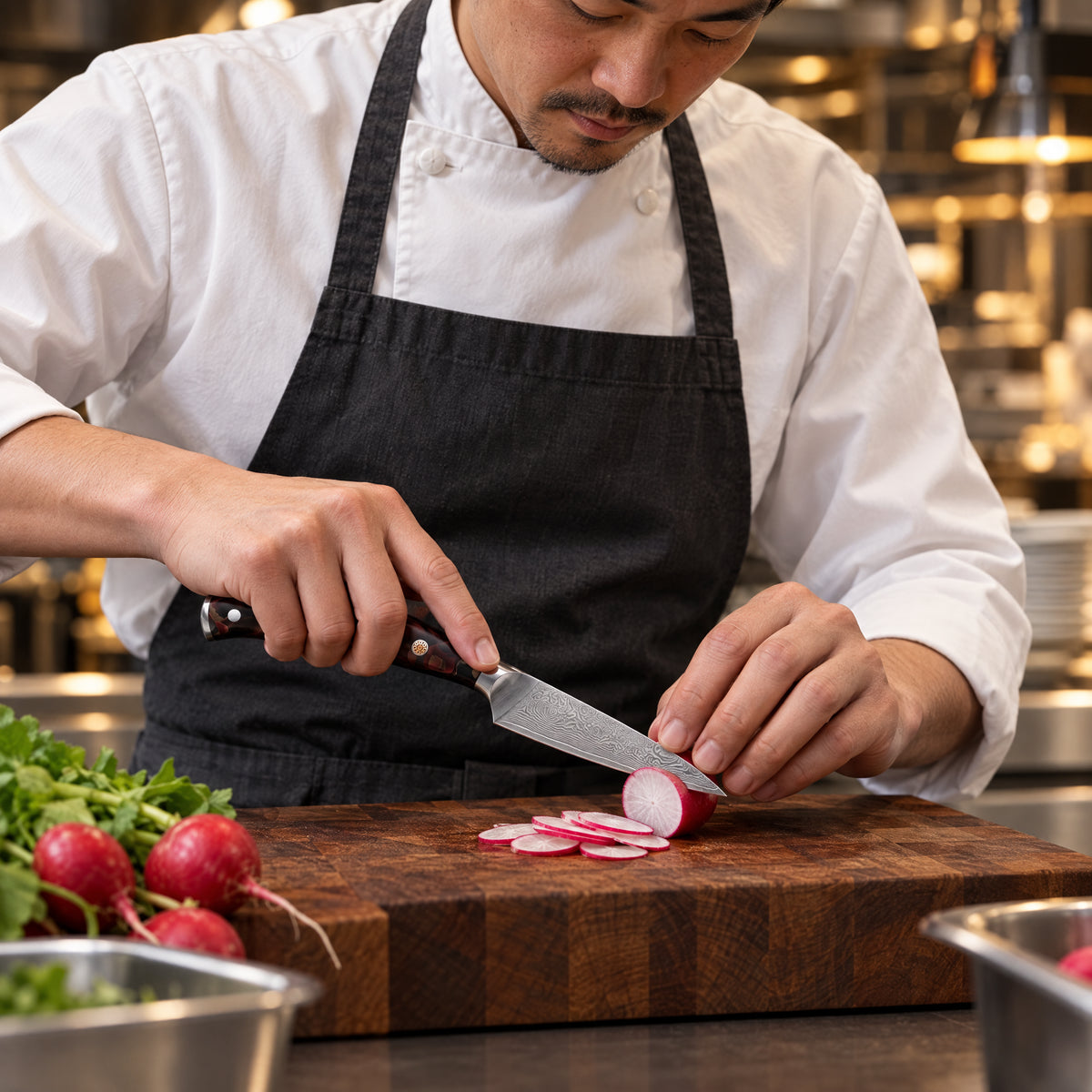 A Japanese chef using the Kongo Paring Knife on a wooden cutting board in a professional kitchen