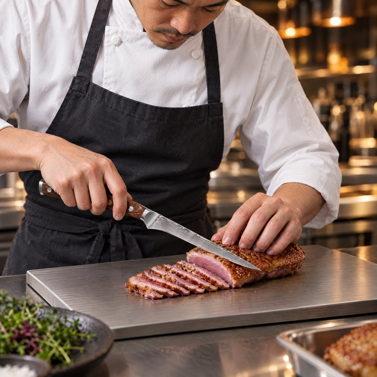 A Japanese chef using the Musashi Honesuki Boning Knife on a titanium cutting board in a professional kitchen