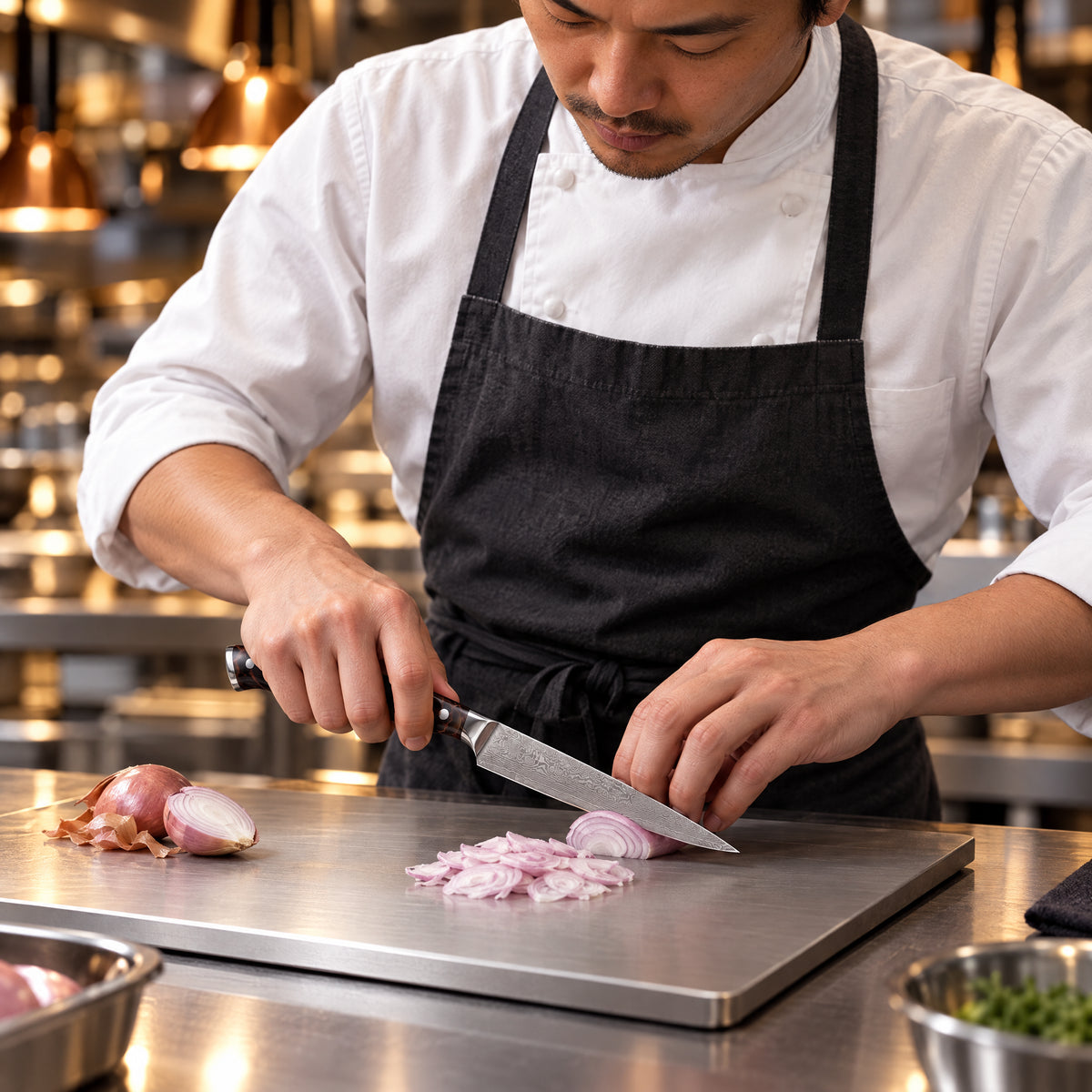 A Japanese chef using the Kongo Utility Knife on a titanium cutting board in a professional kitchen