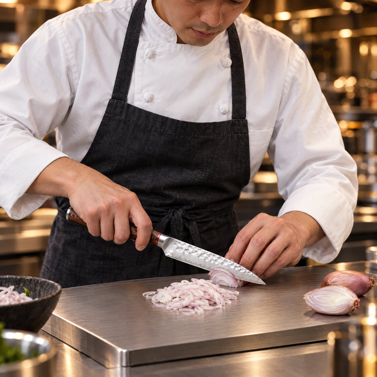 A Japanese chef using the Taiga Utility Knife on a titanium cutting board in a professional kitchen