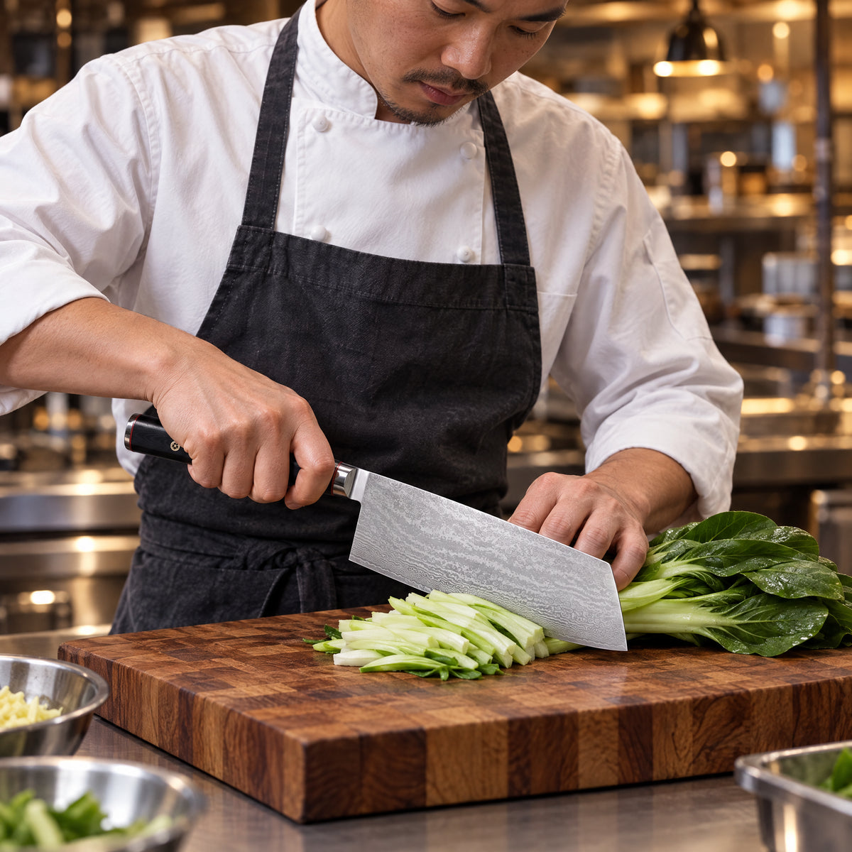 A Japanese chef using the Kurogane Cleaver Knife on a wooden cutting board in a professional kitchen