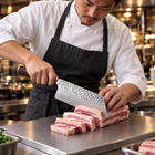 A Japanese chef using the Taiga Vegetable Cleaver Knife on a titanium cutting board in a professional kitchen