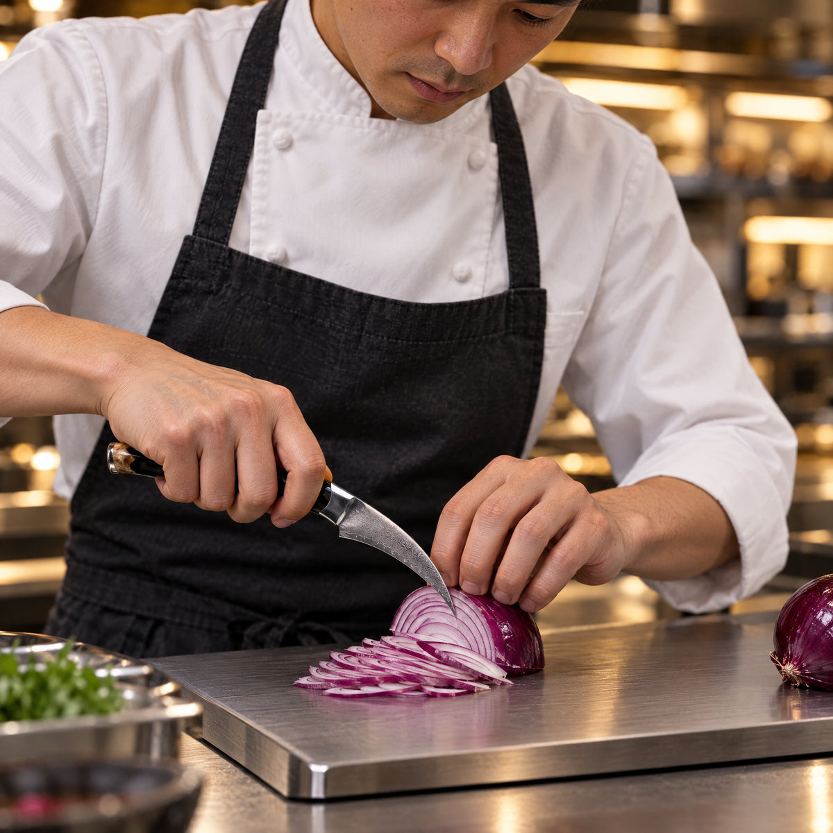 A Japanese chef using the Tsukikage Bird's Beak Peeling Knife on a titanium cutting board in a professional kitchen