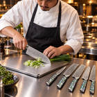 A Japanese chef using the Ryujin Damascus Knife Set on a titanium cutting board in a professional kitchen