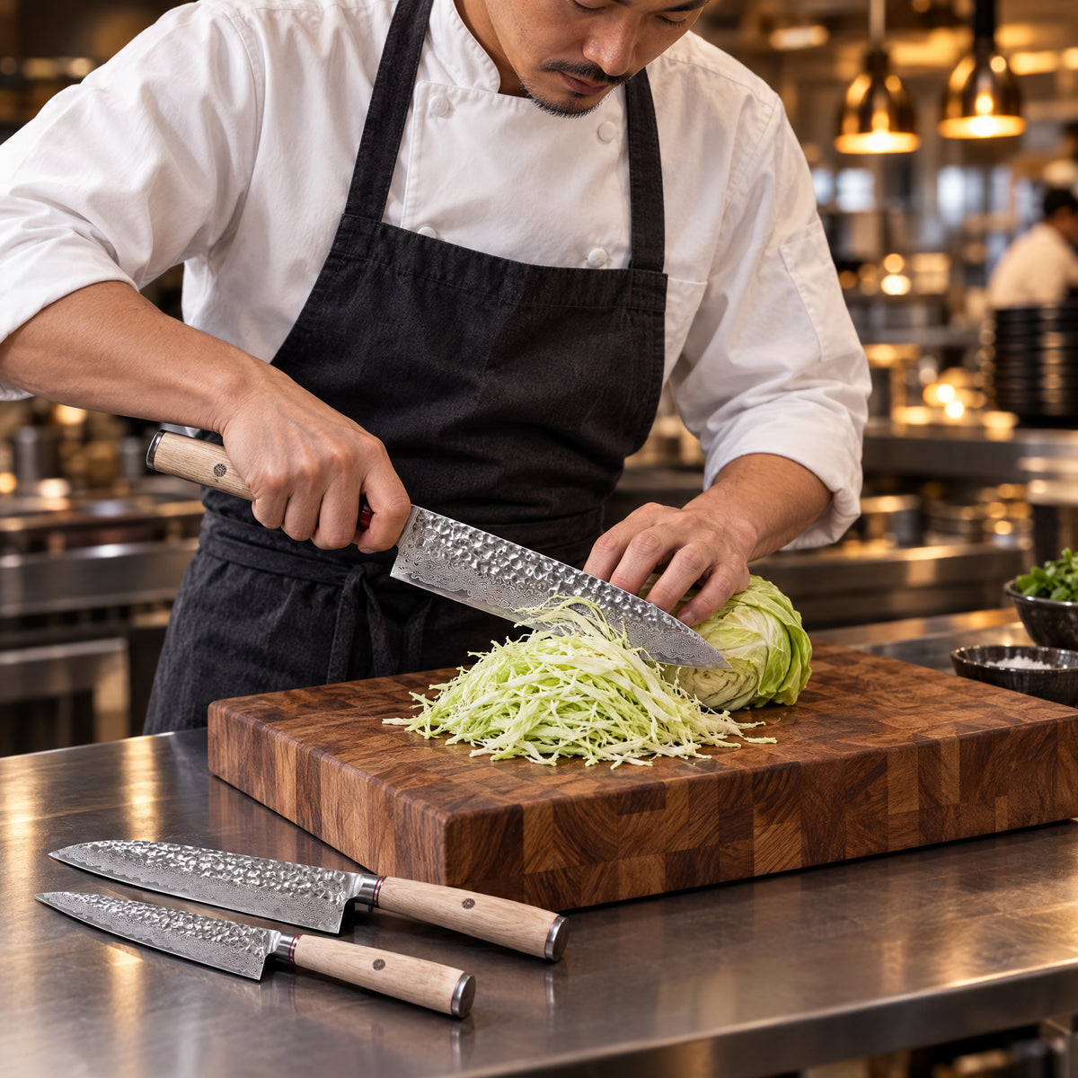 A Japanese chef using the Takumi 2-Piece Knife Set (Gyuto & Petty) on a wooden cutting board in a professional kitchen