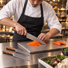 A Japanese chef using the Yamato 3-Piece Knife Set (Gyuto, Nakiri & Petty) on a titanium cutting board in a professional kitchen