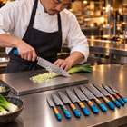 A Japanese chef using the Suijin 9-Piece Knife Set on a titanium cutting board in a professional kitchen