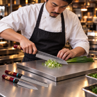 A Japanese chef using the Tenryu 3-Piece Knife Set (Gyuto, Nakiri & Petty) on a titanium cutting board in a professional kitchen
