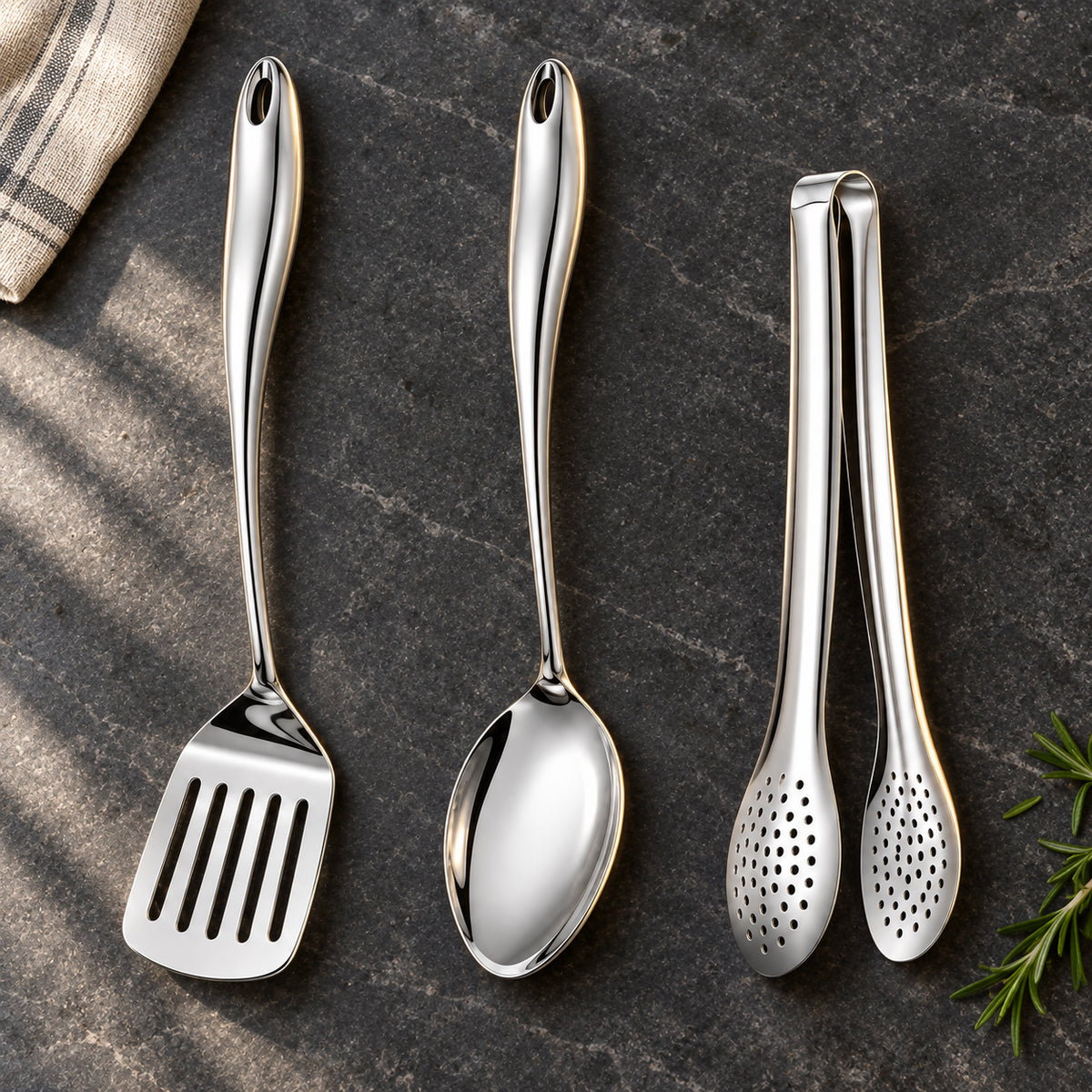 Okura 3-piece utensil set arranged on a charcoal kitchen countertop