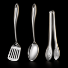 Okura 3-piece utensil set, rounded handles, black studio with subtle warm lighting