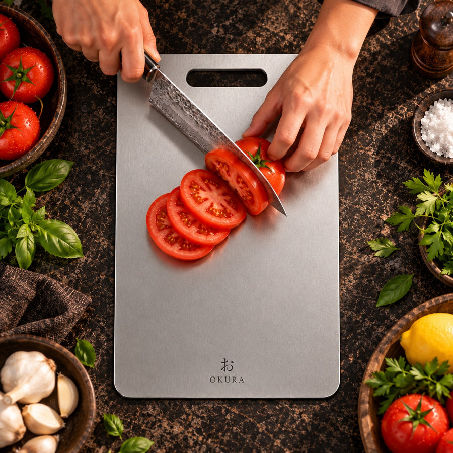 Tomatoes being sliced on an Okura titanium cutting board