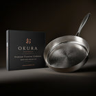 Okura high-wall titanium pan next to the Okura gift box