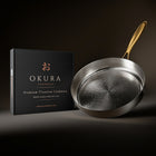 Okura high-wall titanium pan Limited Edition next to the Okura gift box
