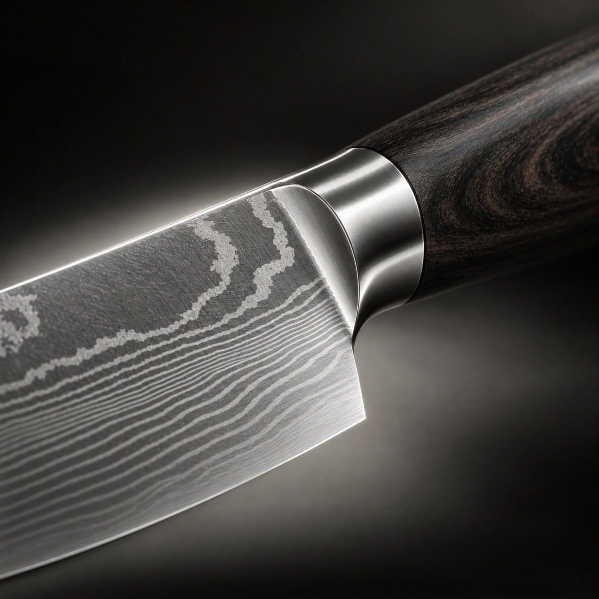 Close-up of the flowing Damascus-style pattern on the Okura 8.1-inch chef’s knife