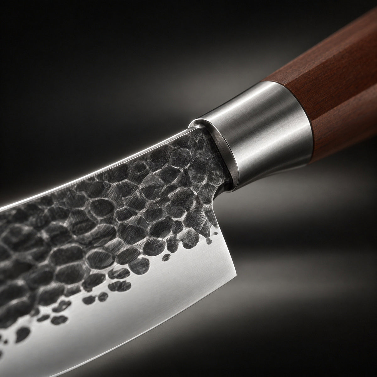 Close-up of the japanese-style hammered stainless steel chef’s knife blade and handle