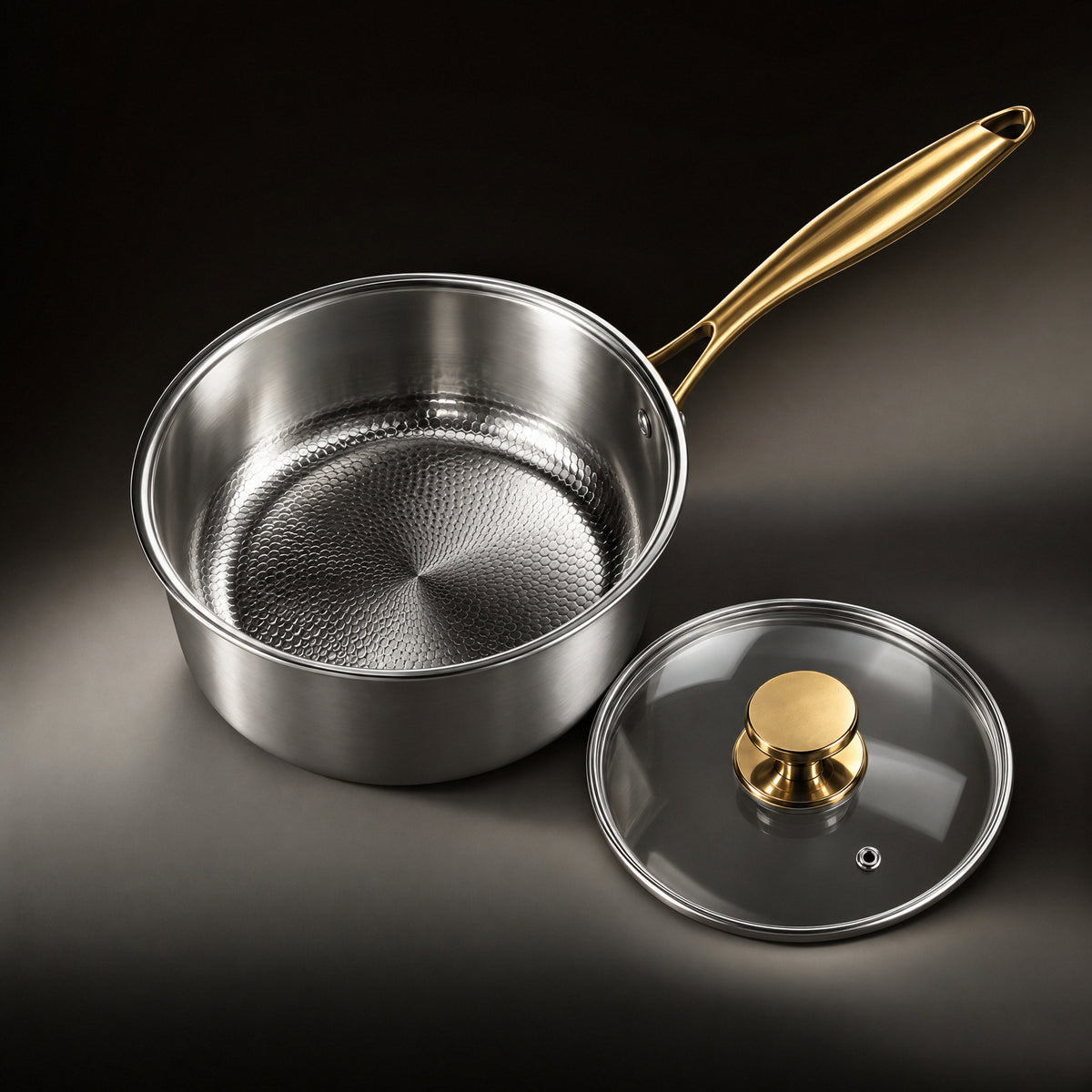 The hammered titanium interior of the Limited Edition saucepan with the glass lid beside it