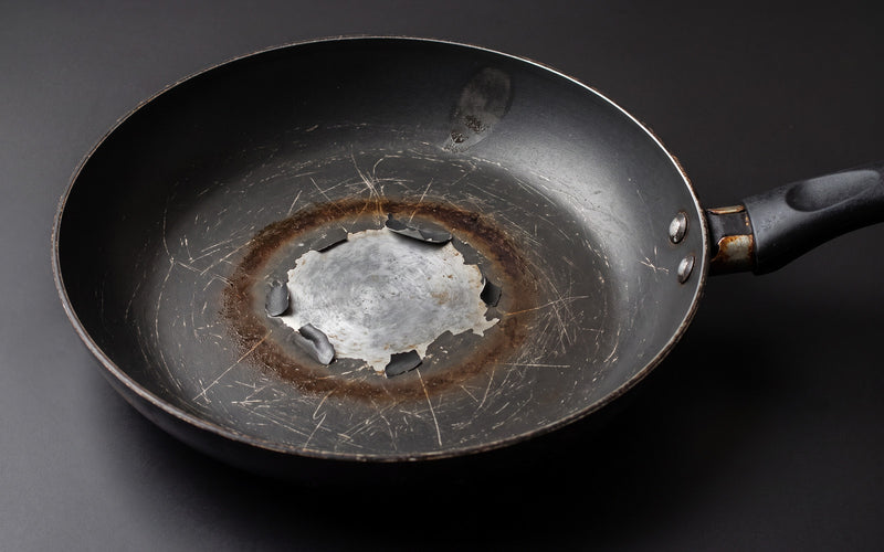Worn non-stick pan with coating peeling in the centre
